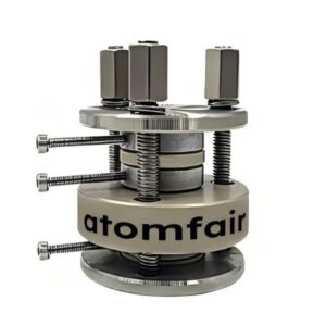 ATOMFAIR® solid-state three-electrode testing fixture split cell assembly on a clean laboratory workbench.