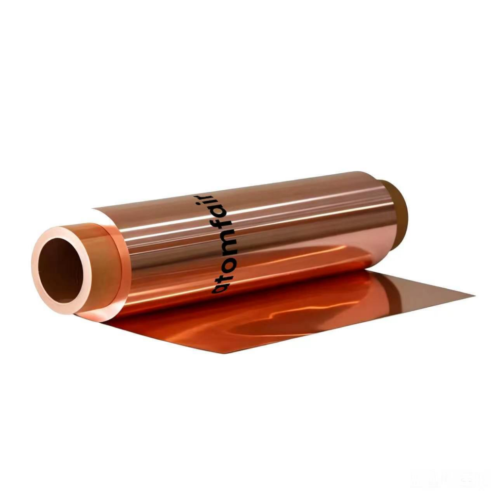 ATOMFAIR® a roll of shiny metallic bronze copper foil on a core, displaying a smooth sheet extending flat onto a white surface.