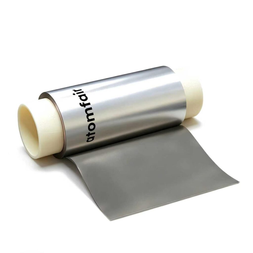 ATOMFAIR® white copper foil roll wound on a white plastic core, showcasing smooth metallic surface on a solid white background.