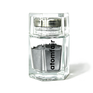 Atomfair® 17-4PH stainless steel MIM powder showing a dark gray metallic fine substance within a clear hexagonal glass bottle.