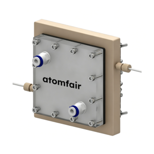 ATOMFAIR® deionization cell with large beige rear block, clear square front plate, and two blue-ringed fluid ports.