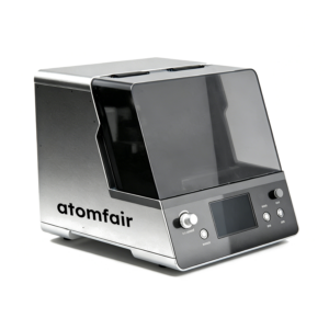 ATOMFAIR® desktop battery 3d printing equipment with a silver metallic body, a dark translucent protective cover, and a front control panel.