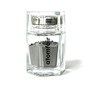 Atomfair® F75 cobalt-chromium-molybdenum MIM powder showing a smooth gray metallic substance inside a clear hexagonal glass bottle.