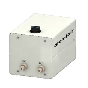 ATOMFAIR® mixing pump system with beige housing, a top black knob, and twin front fluid ports labeled IN and OUT.