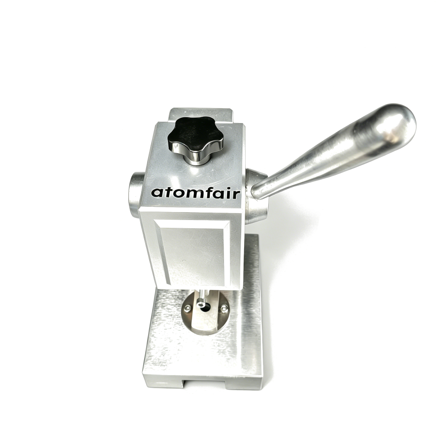 Research-grade high precision coin cell disc cutter with 14mm dia and 0.005-0.5mm range. Burr-free, anti-corrosion, fits gloveboxes. Order now. 1 ATOMFAIR® manual coin cell disc cutting machine tool with a silver metallic block body, a top black knob, and a long steel handle.