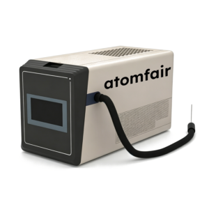 ATOMFAIR® spectrometer with a beige vented chassis, front rectangular screen, and a curved black inlet capillary tube.