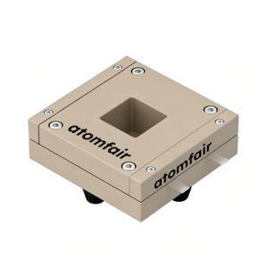 ATOMFAIR® conductivity cell with a square beige PEEK block body, central window opening, and side metal pin tabs.