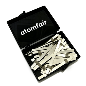 ATOMFAIR® research grade pure nickel battery anode tabs piled inside an open black plastic storage case on a white background.