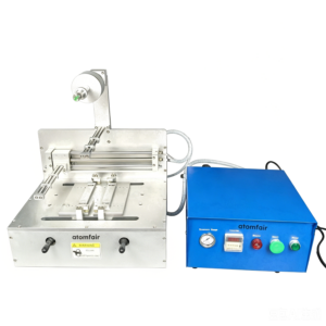 ATOMFAIR® semi-automatic battery stacker with a silver steel stacking mechanism next to a bright blue control box featuring an analog pressure gauge.