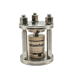 ATOMFAIR® solid state lithium-ion battery test moulds showing two metallic cell fixtures side by side with white and beige ceramic inserts.