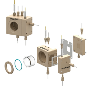 ATOMFAIR® cell 3D view with beige blocks, circular viewport layers, internal split-frame, and assembled unit.