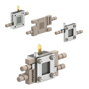 ATOMFAIR® solid electrolyte cell 3D view with clear square windows, serpentine channels, and fully assembled block.