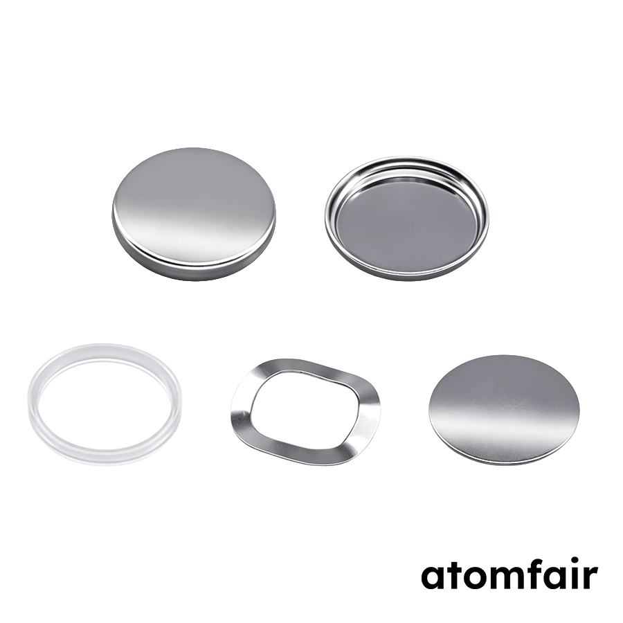 ATOMFAIR® gold titanium nitride TiN coated CR2032 coin cell cases showing textured mesh cap with black gasket and smooth bottom cup.